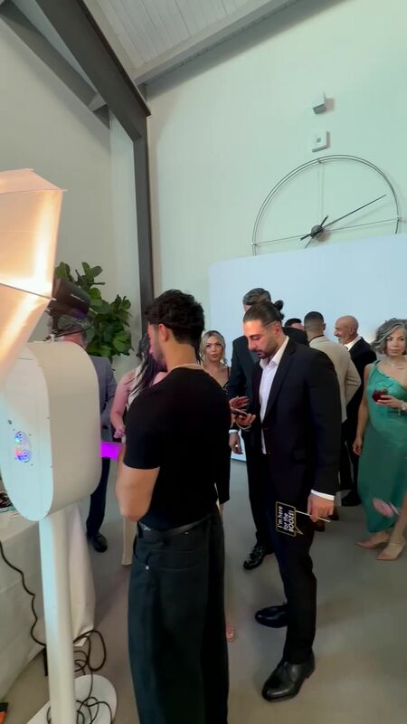 Guests gathering at the booth during a daytime celebration