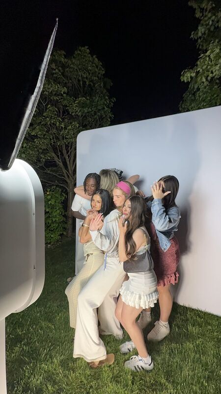 Friends laughing together at the booth